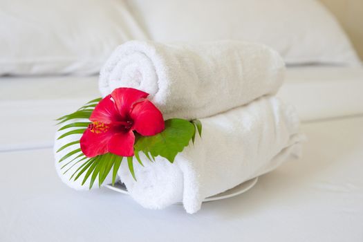 folded towels on bed in hotel room