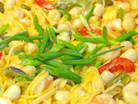 Fresh Pasta and Seafood in a Cream Sauce Garnished with Green Onions