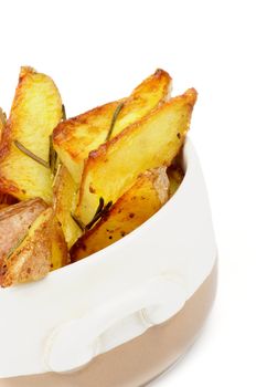 Roasted Potato Wedges with Rosemary in Bowl closeup on white background