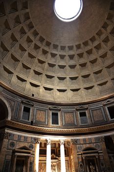 3PM Pantheon Rome Italy Basilica Palatina uilt in 27BC by Agrippa Oldest church in Rome.  The Cupola Oculus Hole in the Ceiling has a sundial effect.  At 3PM every afternoon, the three pillars lit up to tell the time