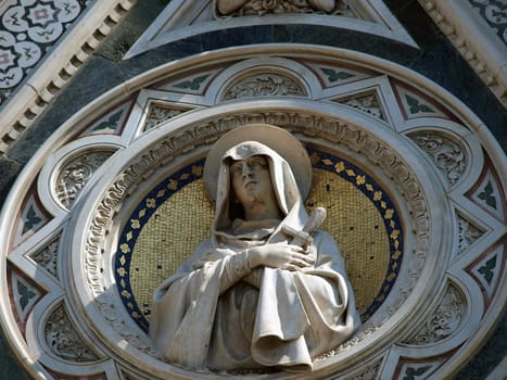 Florence - beautiful composition with  Virgin Mary above the portal on the facade of the Santa Maria del Fiore cathedral