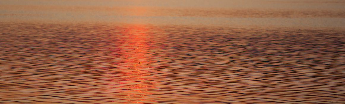 Colour, motion and pattern of a lake at sunset