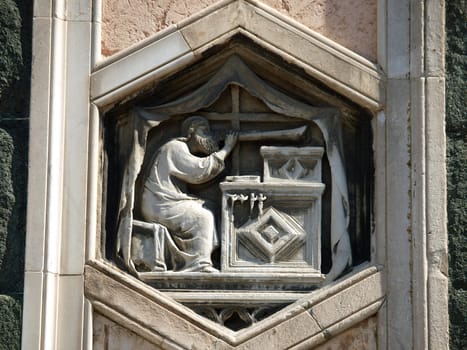 Florence - The hexagonal Relief on the Giottos' Campanile.The hexagonal panels on the lower level depict the history of mankind, inspired by Genesis.
