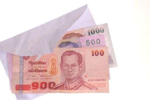 banknotes in an envelope isolated on a white background