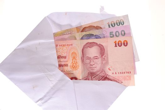 banknotes in an envelope isolated on a white background