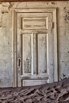 door in a ghosthouse in kolmanskop ghost town near luderitz namibia