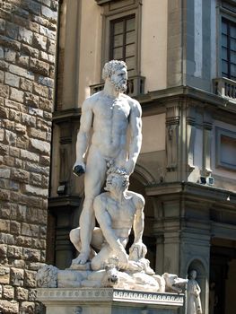 Florence - Sculpture Hercules and Cacus by Bandinelli. The white marble sculpture Hercules and Cacus is to the right of the entrance of the Palazzo Vecchio in the Piazza della Signoria, Florence, Italy.