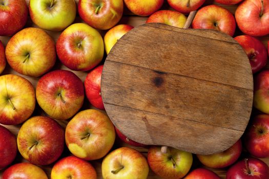 Apples composition with fruits and cutting board with apple shape. Top view. Empty room for text