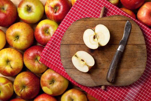 Apples composition with fruits and cutting board with apple shape. Top view. Empty room for text