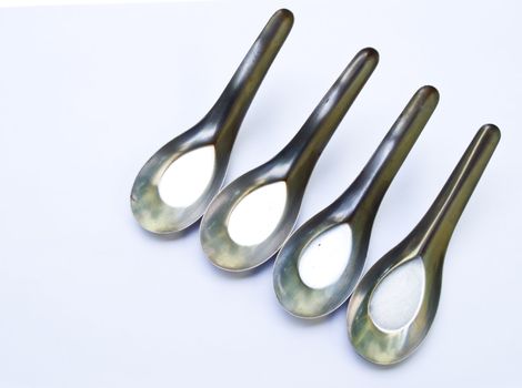 Used stainless stell spoons isolated on white background
