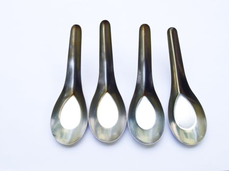 Used stainless stell spoons isolated on white background