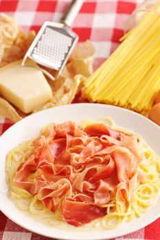 Pasta carbonara over red cloth