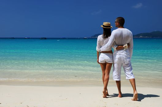 Couple in white on a tropical beach