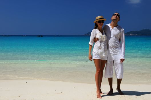 Couple in white on a tropical beach