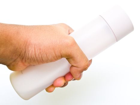 A pink plastic bottle hold by hand isolated on white background