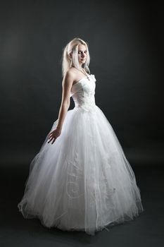 Beautiful girl in white dress on black background