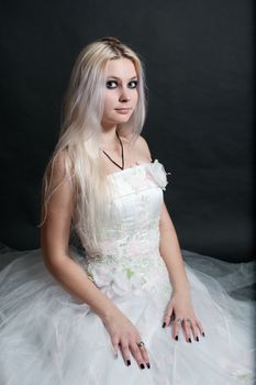 Beautiful girl in white dress on black background