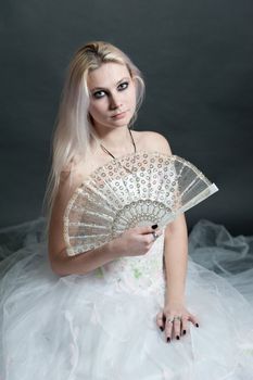 Beautiful girl in white dress on black background