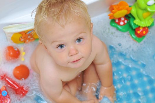 Cute little boy taking a bath