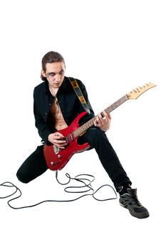 Young guitarist with red guitar on white background