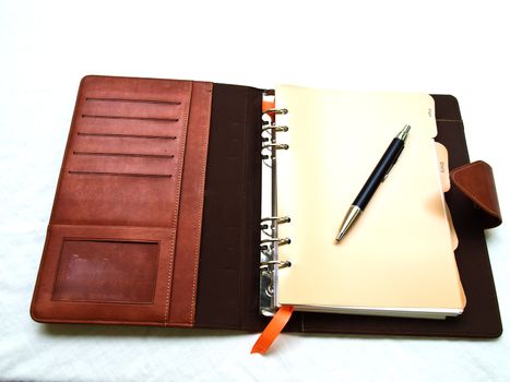 Opened red-brown organizer with a pen