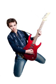 Young guitarist with electric guitar on white background