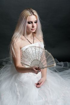 Beautiful girl in white dress on black background