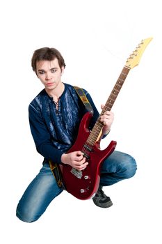 Young guitarist with electric guitar on white background