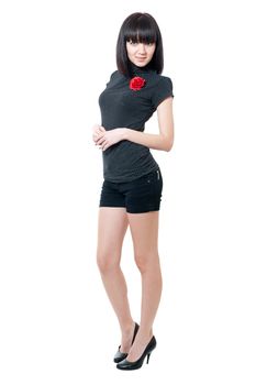 Young girl in black blouse and shorts isolated on white background