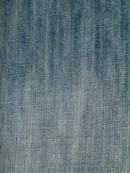 Striped textured used blue jeans denim fabric grunge background