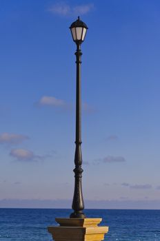 the street lamp against the background of sea and blue sky