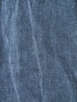 Striped textured used blue jeans denim fabric grunge background