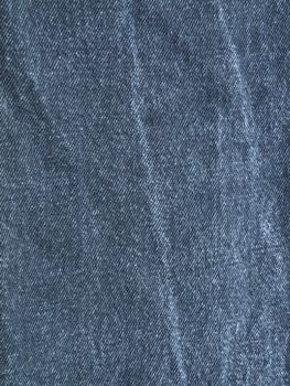 Striped textured used blue jeans denim fabric grunge background