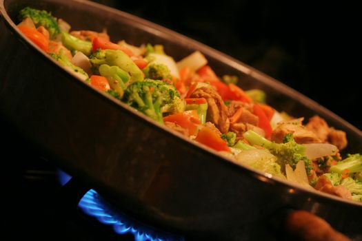 Chicken and vegetable stirfry in a wok;