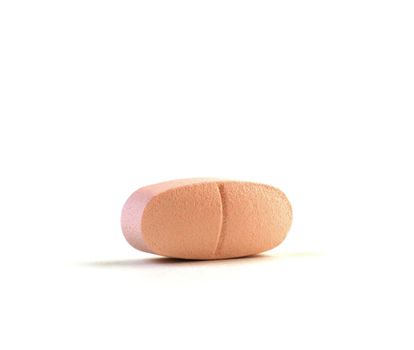 Pink Daily Vitamin Pill Isolated Against a Pure White Background