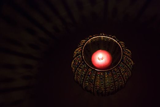 a candle in a candle holder in the dark