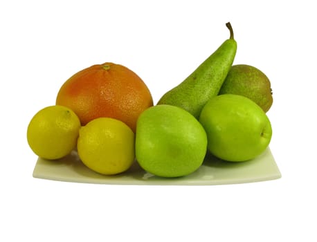 Grapefruit, lemon, pear, green apples on white square dish, isolated on white