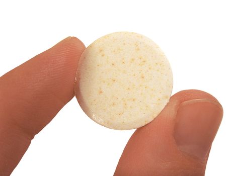 an effervescent tablet between finger and a thumb over white