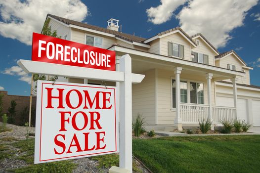 Foreclosure Home For Sale Sign and House with dramatic sky background.