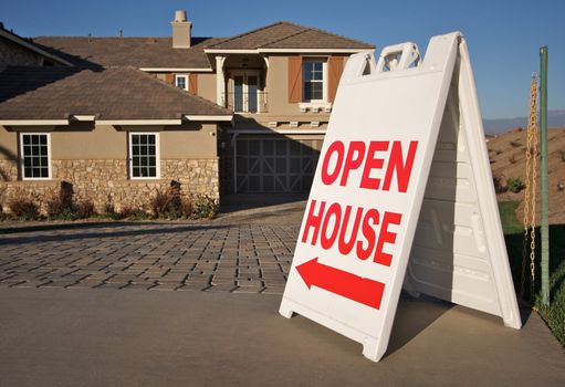 Open House Sign in Front of A Brand New Home. Room for your own message at the top of the sign.