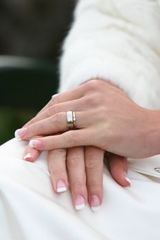 a cropped shot of the hands of a newly married bride, ring visible