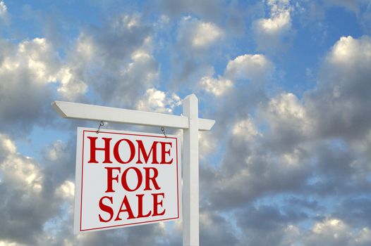 Home For Sale sign on dramatic cloudy background.