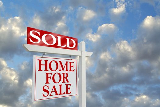 Sold Home for Sale sign on dramatic clouds background with room for your message