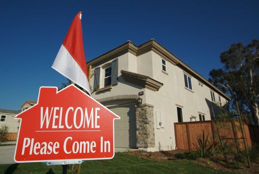 Welcome, Please Come In Real Estate Sign in Front of New Home