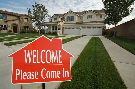 Welcome, Please Come In Real Estate Sign in Front of New Home