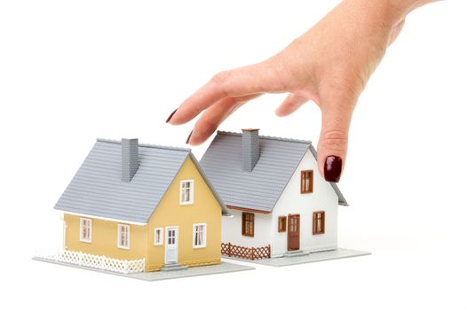 Female hand reaching for house isolated on a white background.