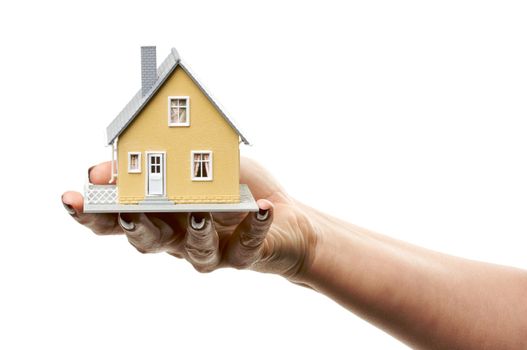 Female hand holding a house isolated on a white background.