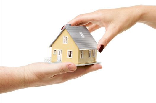 Female hand reaching for a house isolated on a white background.