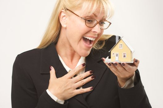 Female holding small house.