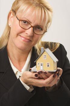 Female holding small house.